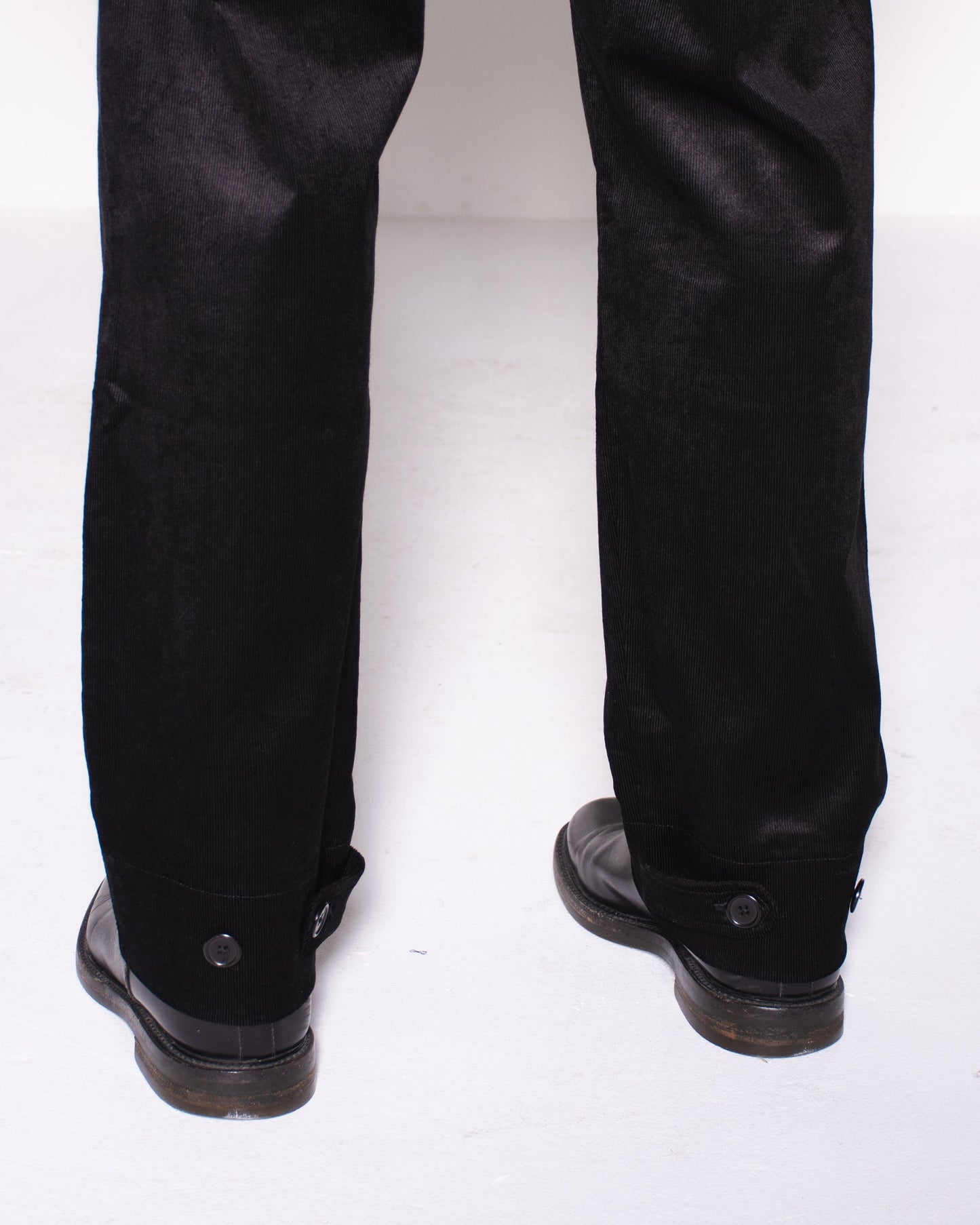 Man wearing a black snake velvet and silk suit on a white background