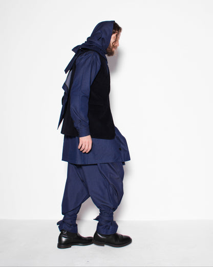 Person wearing a blue outfit with a hood on a white background