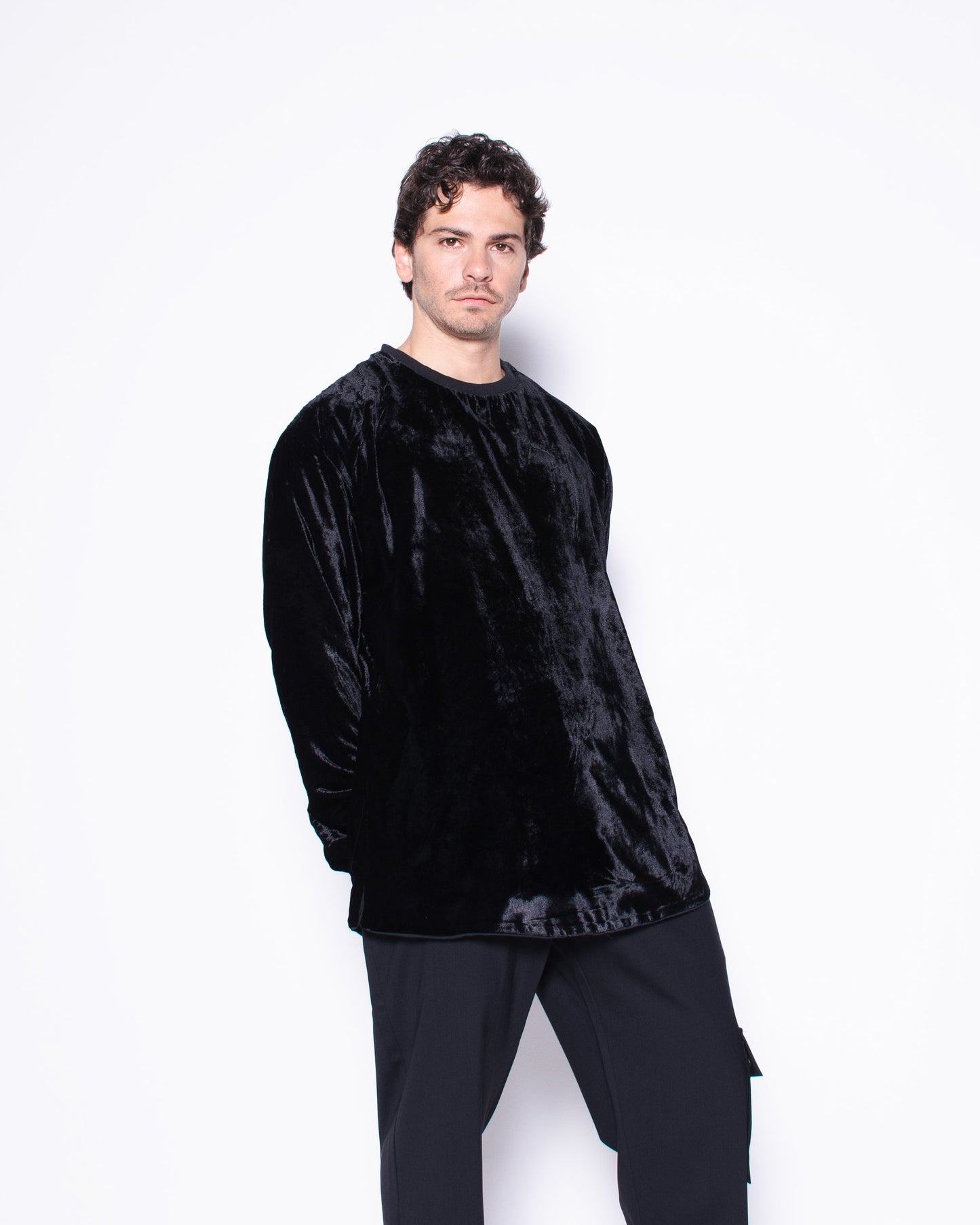 Man wearing a black outfit with a white background