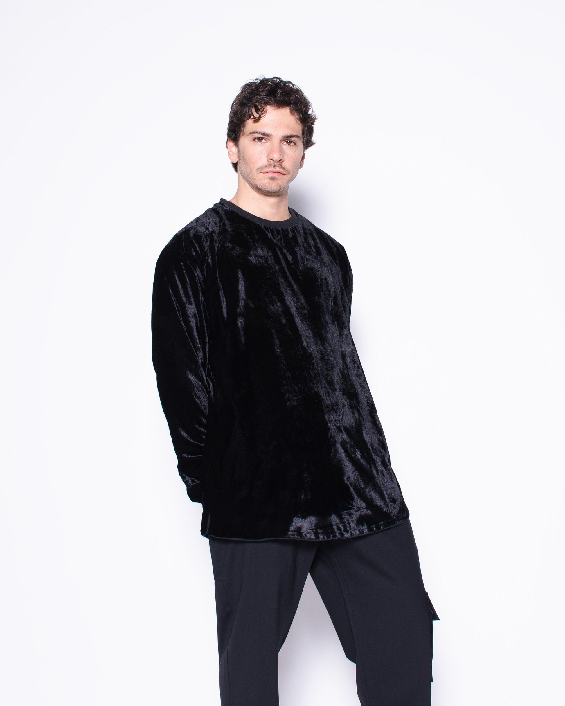 Man wearing a black outfit with a white background