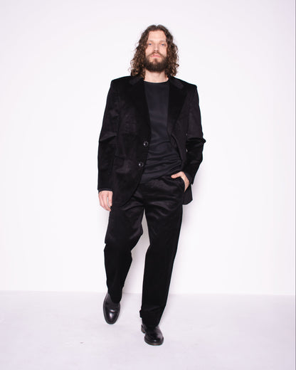 Man wearing black snake velvet and silk  pants on a white background