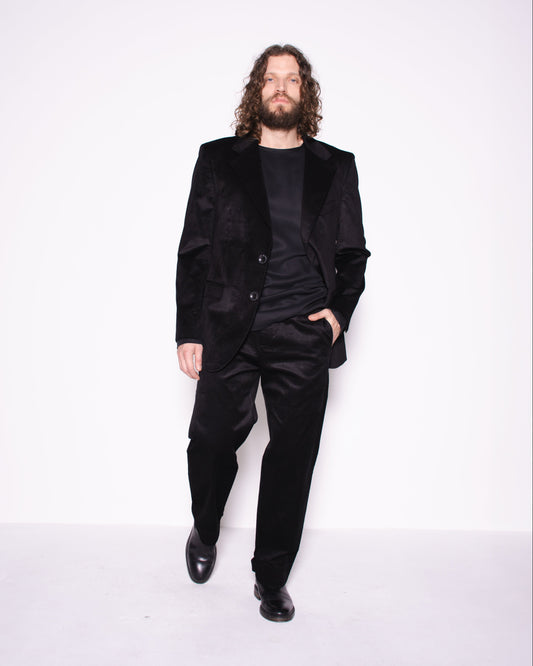 Man wearing black snake velvet and silk  pants on a white background