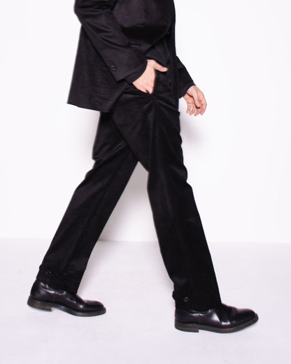 Man wearing a black snake velvet and silk suit on a white background