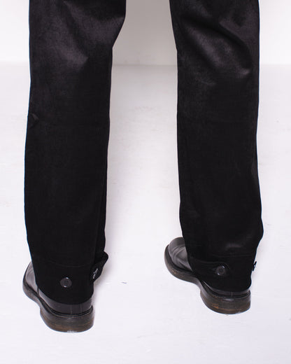 Man wearing a black snake velvet and silk suit on a white background