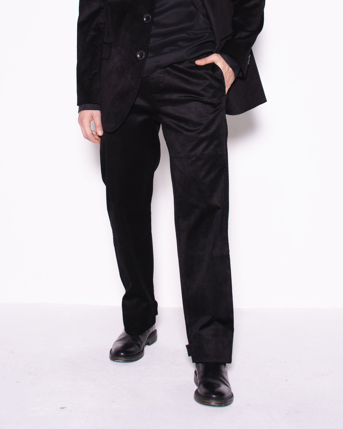 Man wearing a black snake velvet and silk suit on a white background