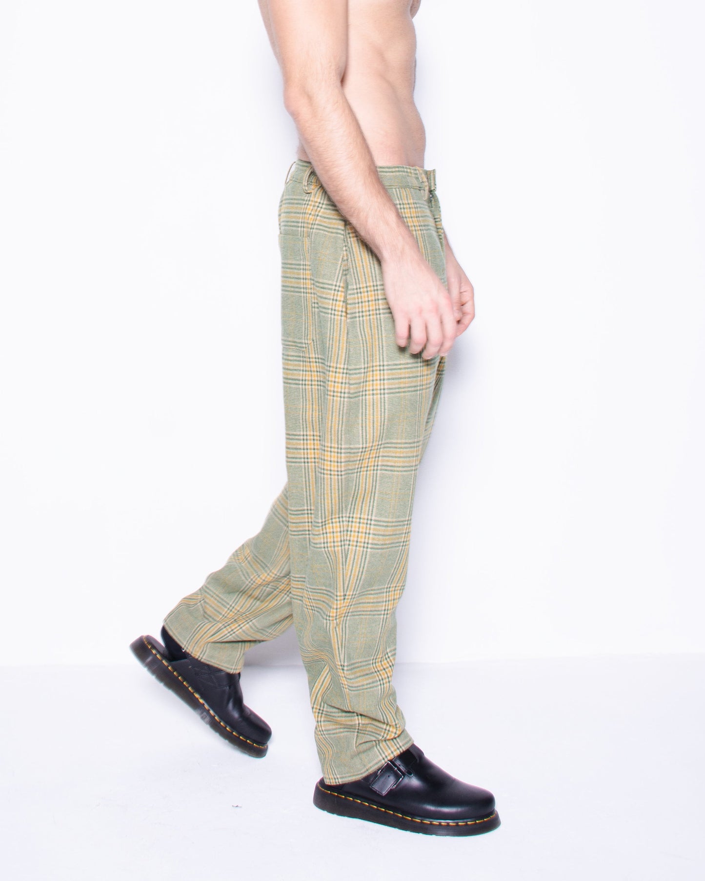  Person wearing green english wool striped  plaid  pants on a white background