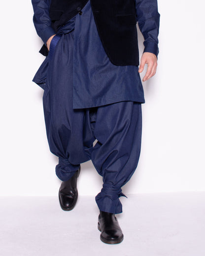 Person wearing a blue outfit with a hood on a white background