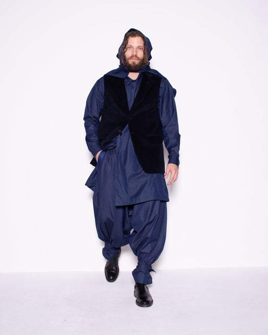 Person wearing a blue outfit with a hood and black vest on a white background