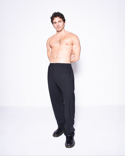 Man wearing black italian wool pants on a white background