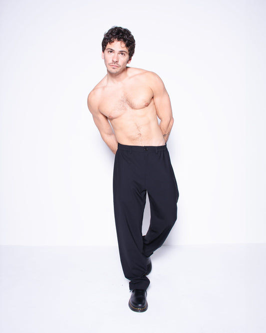 Man wearing black italian wool pants on a white background