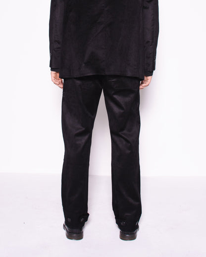 Man wearing a black snake velvet and silk suit on a white background