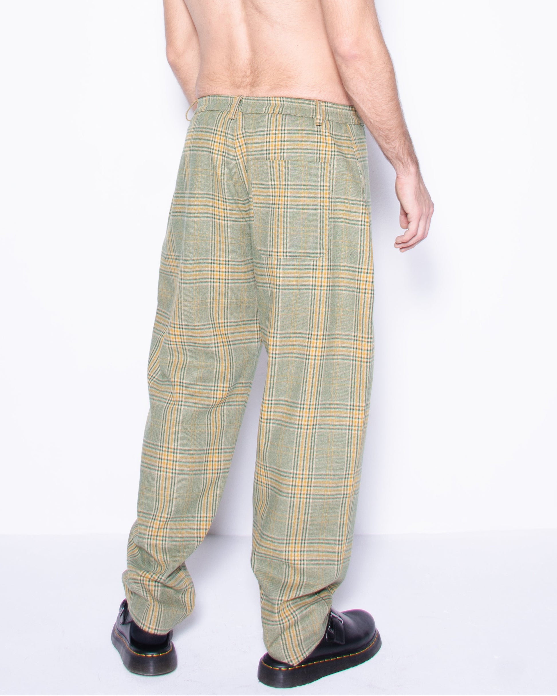  Person wearing green english wool striped  plaid  pants on a white background